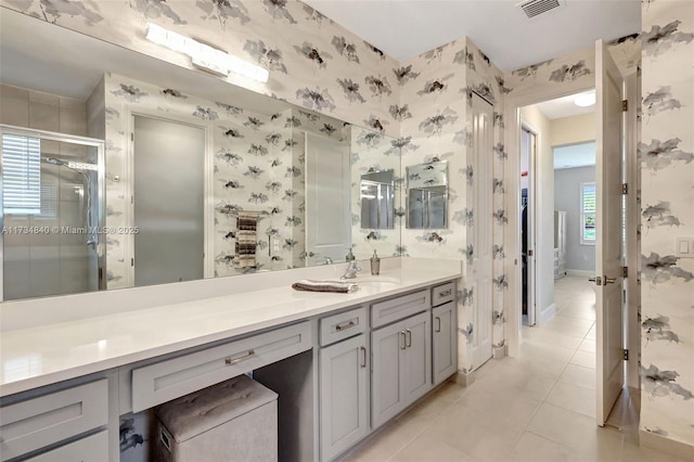 full bathroom featuring wallpapered walls, tile patterned floors, a shower stall, vanity, and baseboards