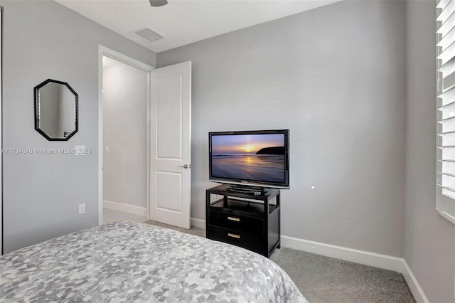bedroom with carpet floors and baseboards