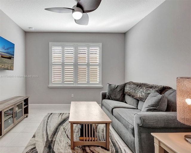 living room featuring ceiling fan and light tile patterned flooring