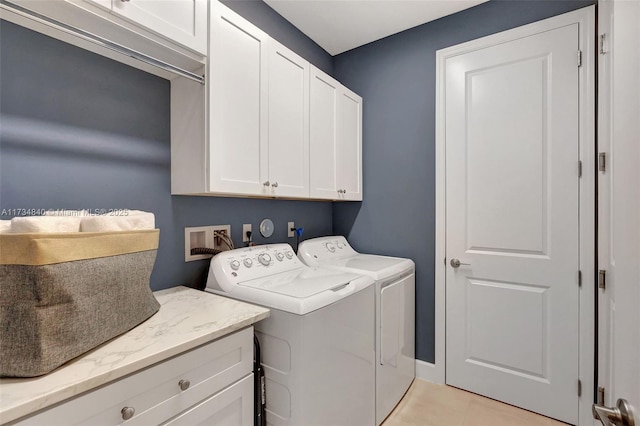 washroom featuring cabinet space, independent washer and dryer, and light tile patterned flooring