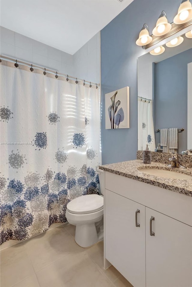 full bathroom featuring tile patterned floors, toilet, vanity, and a shower with shower curtain