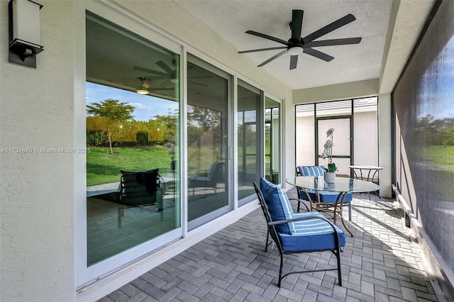 sunroom / solarium with a ceiling fan