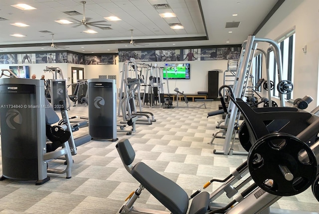 gym with a ceiling fan and light colored carpet