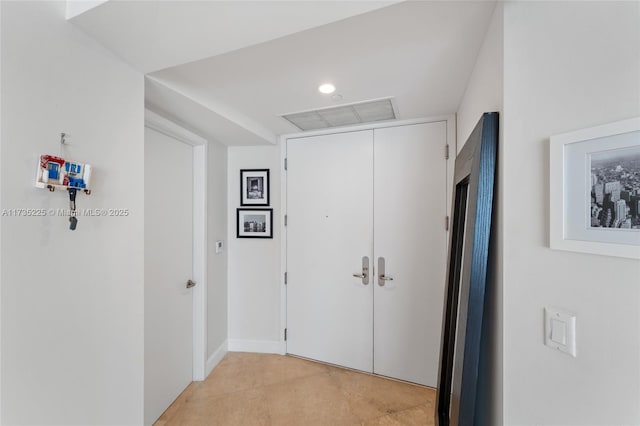 hall with light tile patterned floors