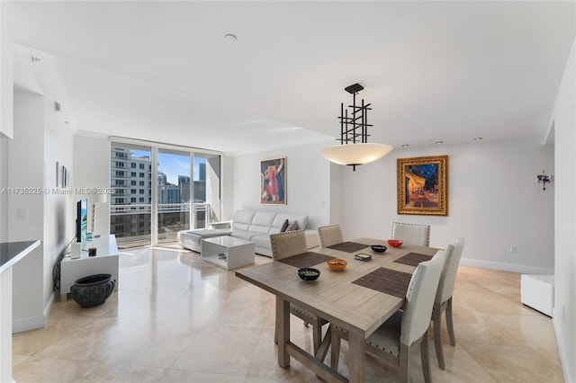 dining space with expansive windows and light tile patterned flooring