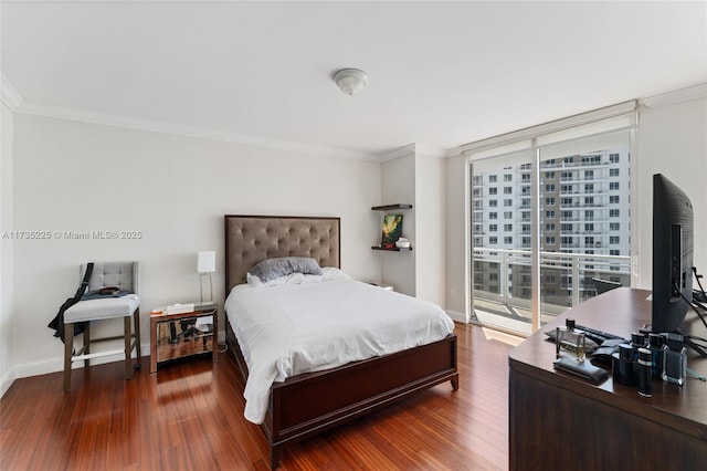 bedroom with dark wood-type flooring, ornamental molding, expansive windows, and access to outside