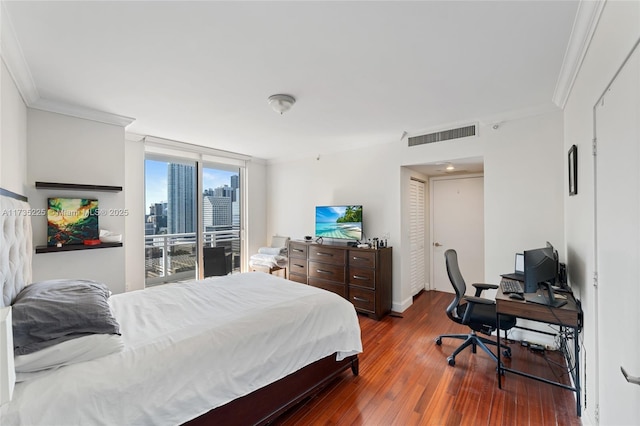 bedroom featuring crown molding, floor to ceiling windows, dark hardwood / wood-style flooring, and access to exterior