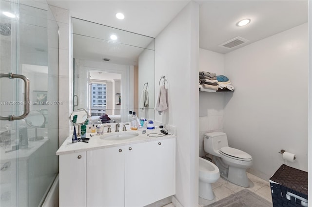 bathroom with a bidet, vanity, a shower with door, and toilet