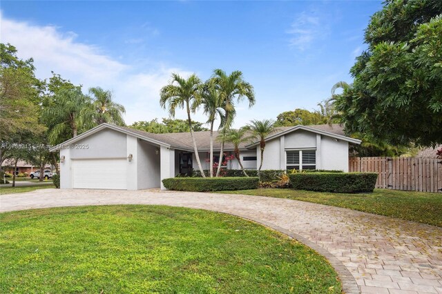 ranch-style house with a garage and a front yard