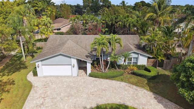 view of front of property featuring a garage and a front lawn