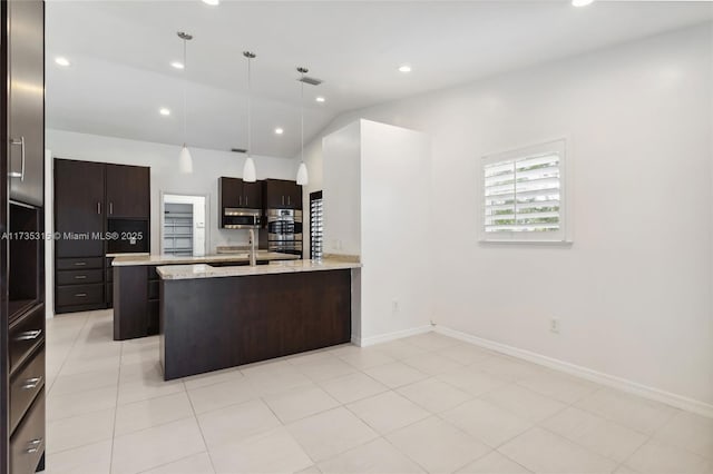 kitchen with light tile patterned flooring, appliances with stainless steel finishes, lofted ceiling, hanging light fixtures, and light stone counters