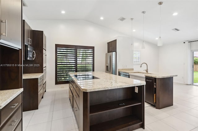 kitchen with lofted ceiling, hanging light fixtures, dark brown cabinetry, black appliances, and an island with sink