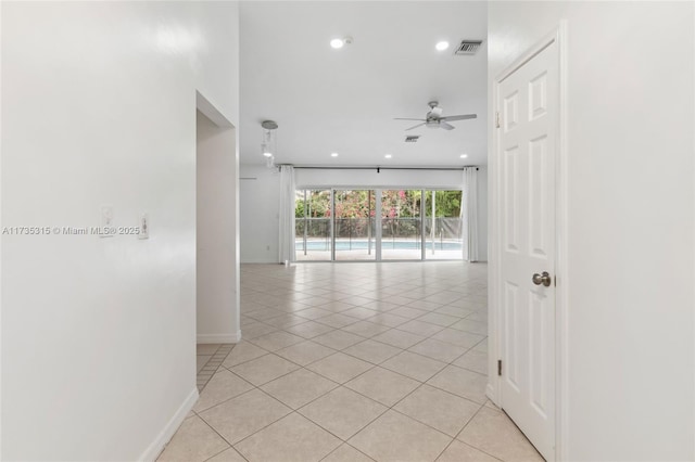 unfurnished room with ceiling fan and light tile patterned floors