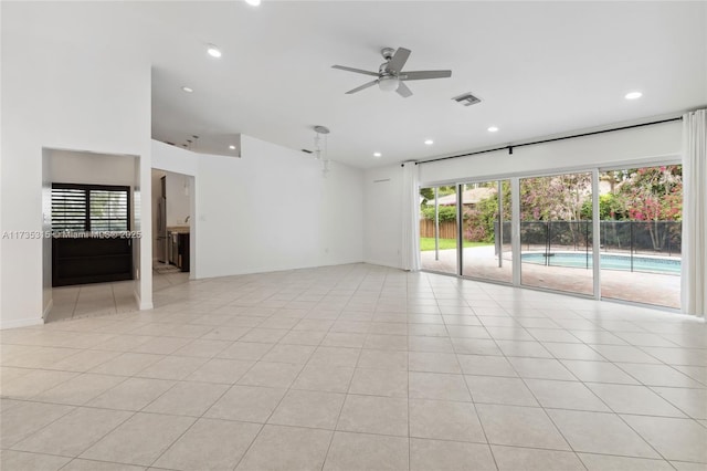 spare room featuring ceiling fan and light tile patterned floors