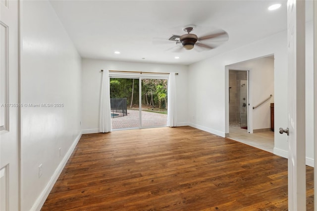 spare room with hardwood / wood-style flooring and ceiling fan