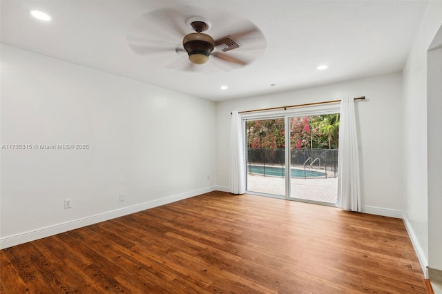 unfurnished room with hardwood / wood-style flooring and ceiling fan