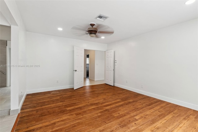 empty room with hardwood / wood-style flooring and ceiling fan