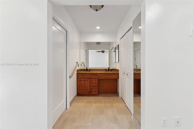 corridor featuring sink and light tile patterned floors