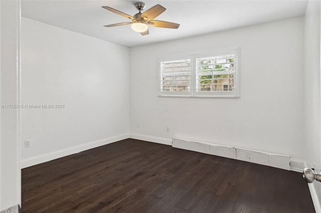 spare room featuring ceiling fan and dark hardwood / wood-style flooring