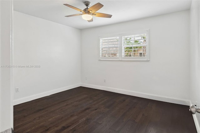 spare room with ceiling fan and dark hardwood / wood-style floors