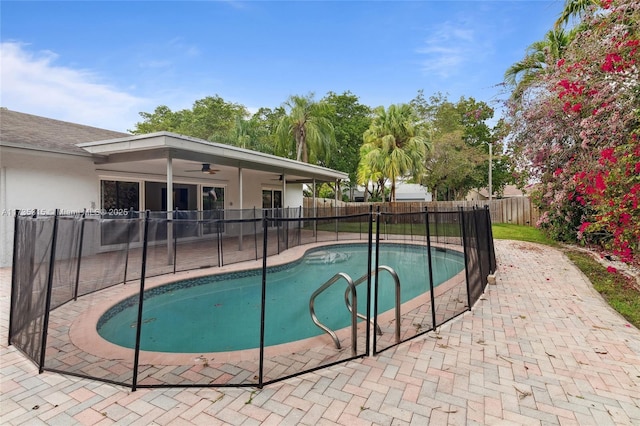 view of swimming pool with ceiling fan and a patio area