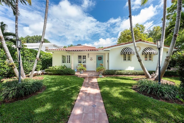 mediterranean / spanish-style house with a front yard