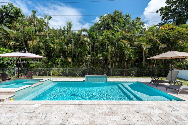 view of swimming pool with an in ground hot tub and a patio