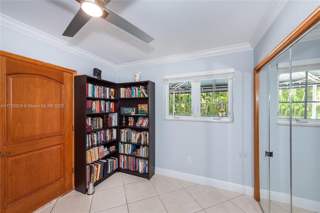 interior space featuring crown molding, a healthy amount of sunlight, light tile patterned floors, and ceiling fan