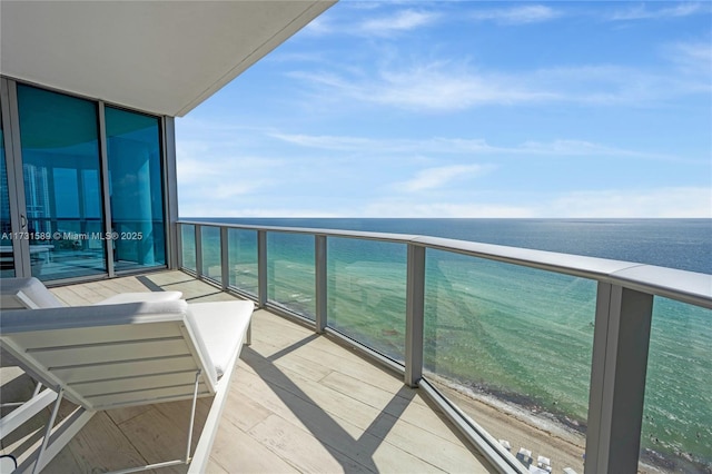 balcony with a water view and a beach view