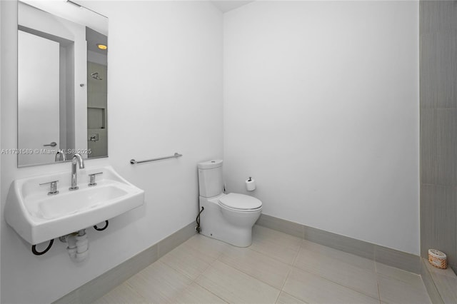 bathroom with sink, tile patterned floors, and toilet