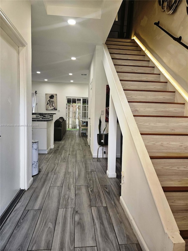 staircase featuring hardwood / wood-style flooring