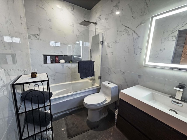 full bathroom featuring vanity, bathtub / shower combination, tile walls, and toilet