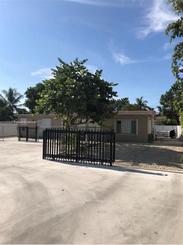 obstructed view of property with a gate and fence