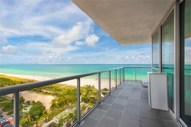 balcony with a view of the beach and a water view