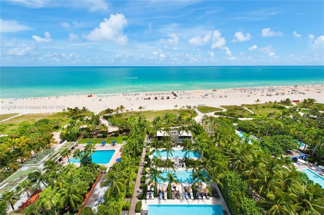 birds eye view of property with a water view and a view of the beach