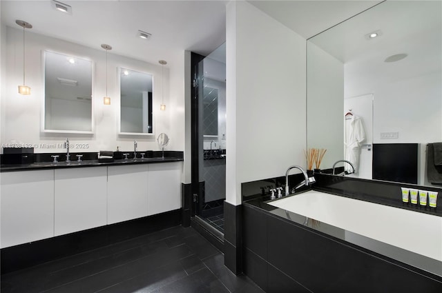 bathroom featuring vanity and a shower with door