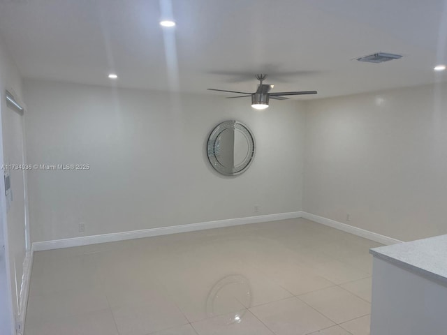 tiled empty room with ceiling fan