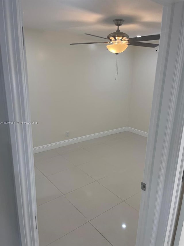 tiled empty room with ceiling fan