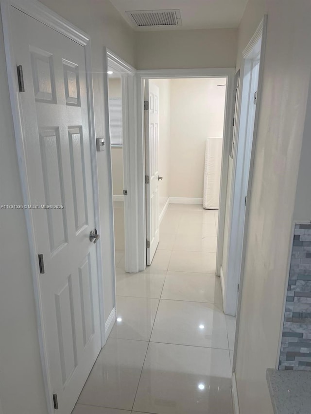 corridor featuring light tile patterned floors