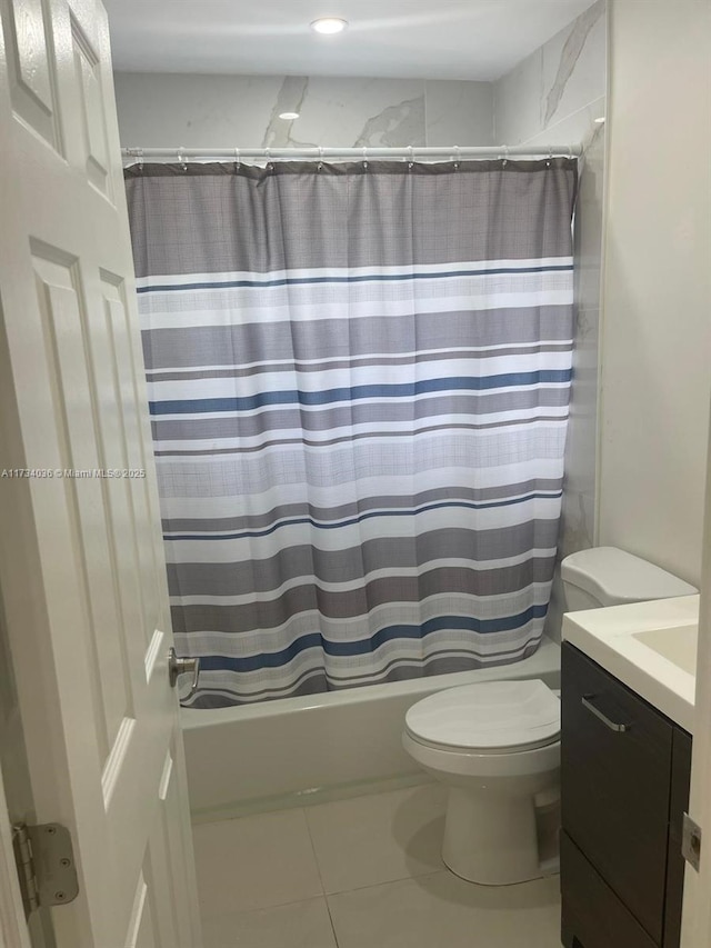 full bathroom featuring vanity, tile patterned flooring, toilet, and shower / bath combo with shower curtain