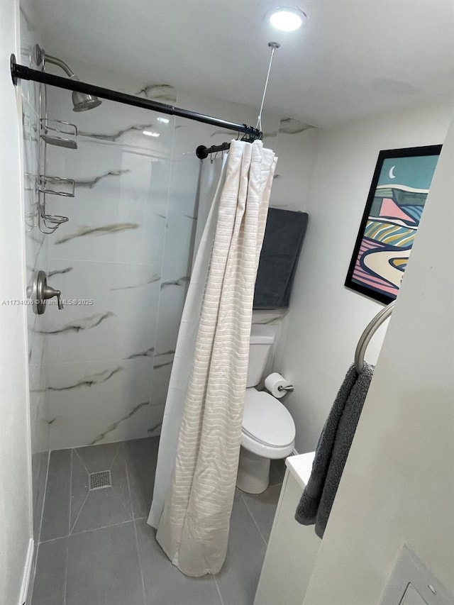 bathroom featuring tile patterned flooring, toilet, and a shower with shower curtain