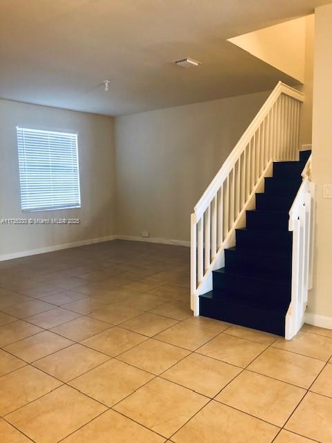 staircase featuring tile patterned floors