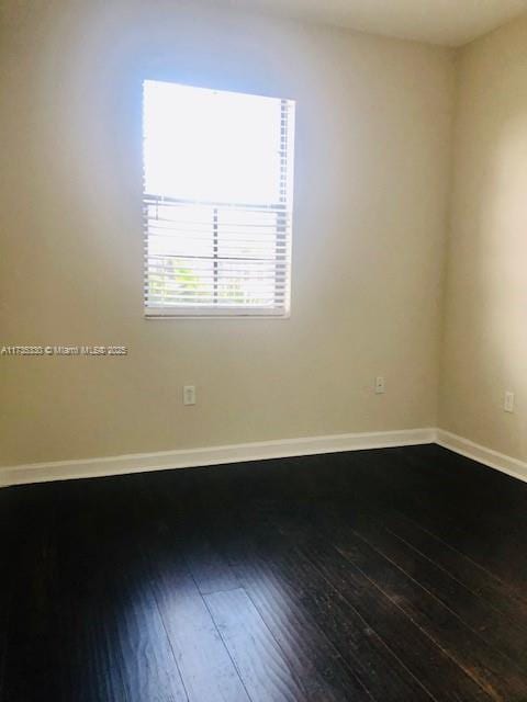 spare room featuring hardwood / wood-style flooring