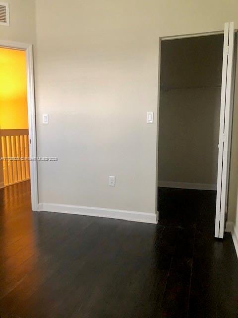 spare room with dark hardwood / wood-style flooring