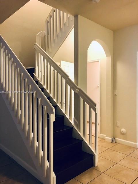 staircase with tile patterned flooring