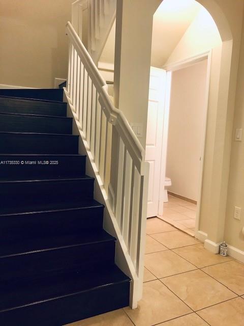 stairs with tile patterned flooring