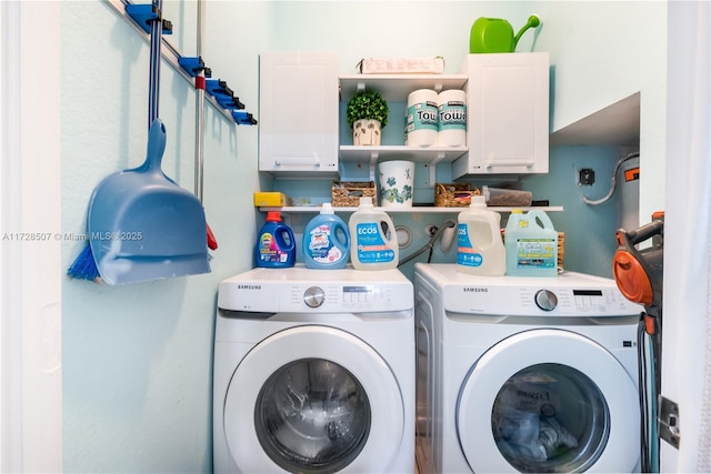 laundry room with cabinets and washer and clothes dryer