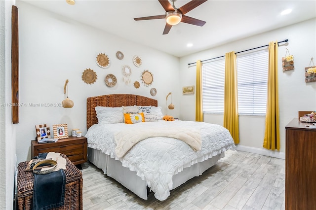 bedroom featuring ceiling fan and light hardwood / wood-style flooring