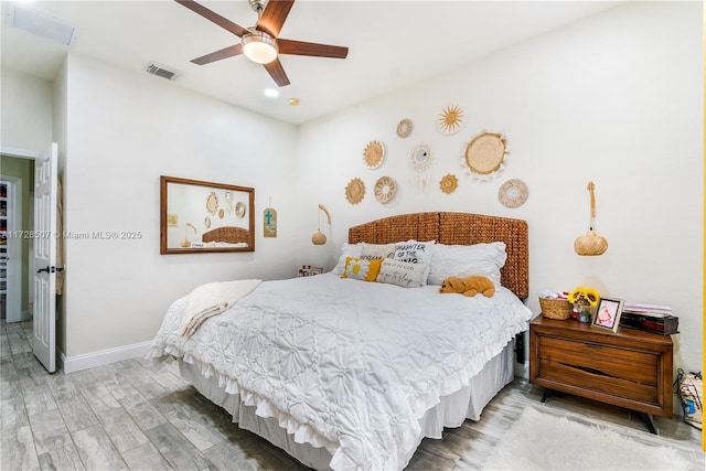 bedroom with wood-type flooring and ceiling fan