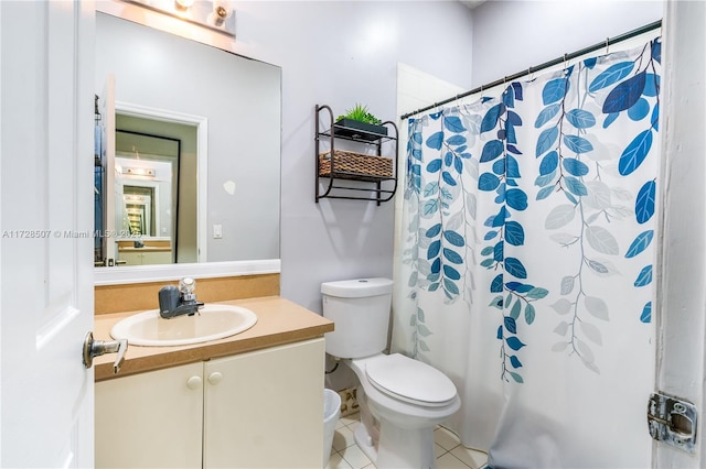 bathroom featuring vanity, walk in shower, tile patterned floors, and toilet